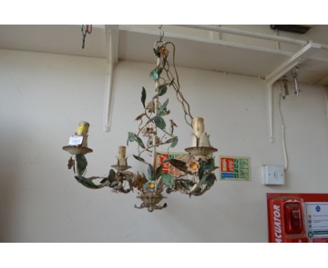 An ornate four branch light fitting with flower decoration