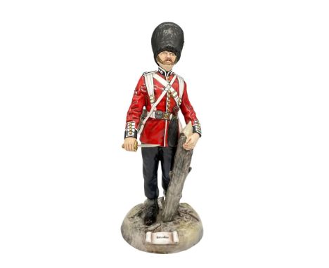 Handmade and hand painted figure dressed in red and white jacket holding a knife and tree trunk. Michael Sutty backstamp. Mod