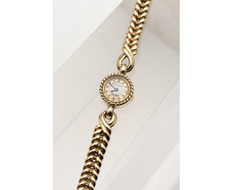 Montre bracelet femme Jaeger Lecoultre en or jaune .750, cadran blanc signé Marchak et Jaeger, aiguilles bleuies, circa 1950.