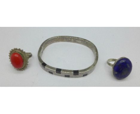 A silver bangle and two silver rings including lapis lazuli, both M