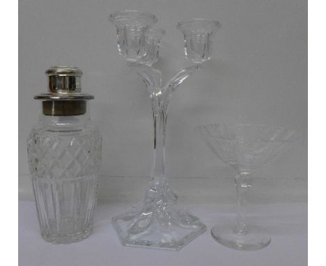 A cocktail glass. a glass candlestick and a glass and plated cocktail shaker