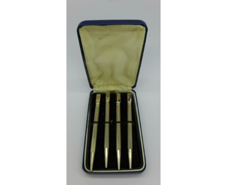 A set of four silver and enamel bridge pencils, cased