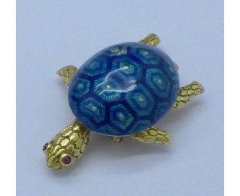 An 18ct gold and blue guilloche enamelled turtle brooch with circular cut ruby eyes, signed Boucheron, length 4cm, dated 1963