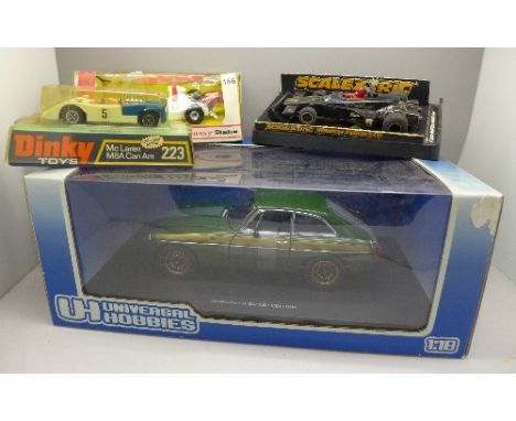 Four vehicles; Dinky Toys 223 McLaren M8A Can Am, Corgi 156 Graham Hill's Embassy Shadow, a 1:18 Universal Hobbies MGB GT and