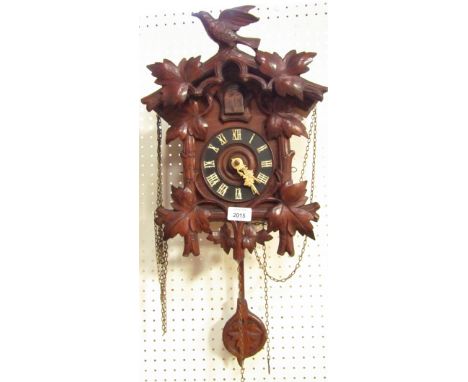 A Black Forest pine cuckoo clock, with swallow branch top, weights and pendulum.