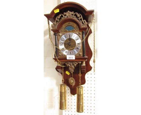 A Dutch mahogany wall clock, with dome top and gilt moon phase above a Roman numeric dial, with pendulum and brass weights.