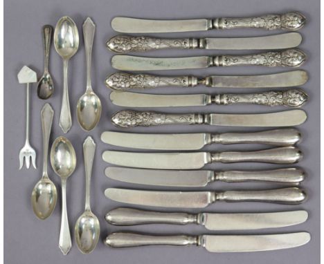 A set of six Edwardian tea knives, the loaded silver handles with embossed floral decoration, Sheffield 1904; a similar set o