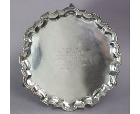 An Edwardian silver salver with raised pie-crust border, the centre with engraved inscription: “Presented to Miss Darling on 