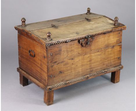 A 20th century Eastern hardwood trunk with a hinged half lid, carved decoration &amp; iron handles, on short stock feet, 30½”