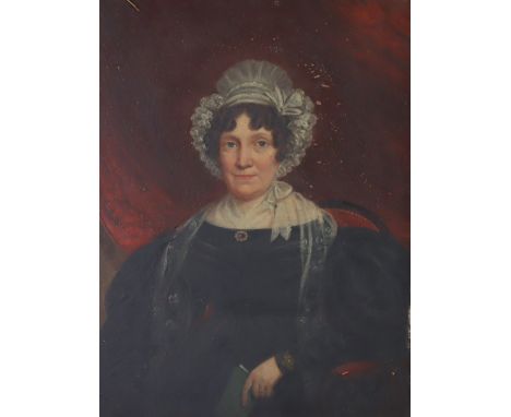 ENGLISH SCHOOL, early 19th century.  A portrait of Mrs George Newby, half-length seated holding a book; oil on mahogany panel