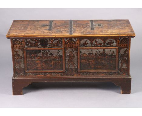 A 17th century continental cedarwood cassone with all-over pokerwork &amp; blind-carved decoration, the hinged lid with iron 