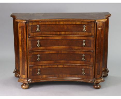An 18th century-style German walnut concave-front commode with crossbanding &amp; moulded edge to the shaped top, fitted four