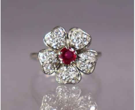 A ruby &amp; diamond flower-head ring set centre round-cut ruby, each of the five petals set four small graduated diamonds, t