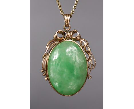 A green jade oval pendant in 14K ribbon-bow &amp; scroll mount, on 14K fine-link necklace.