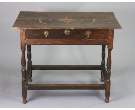 A late 17th century oak side table fitted with a single frieze drawer with brass drop handles, on turned legs joined by plain