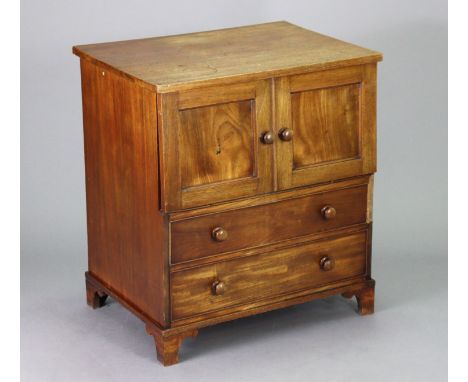 A Victorian mahogany chest commode with a plain rectangular hinged top above pair of faux panel doors enclosing the fitted in