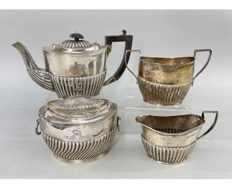 EDWARD VII SILVER BACHELOR'S TEA SET, Birmingham 19091, small half fluted oval, with matched tea caddy by Carrington & Co., L