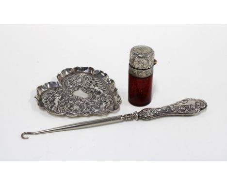 An Edwardian silver dish, heart shaped with embossed cherubs, London 1903, 11cm long, together with a silver handled button h
