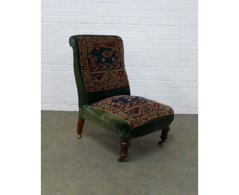 Victorian carpet upholstered  low chair, mahogany legs and brass castors, 58 x 85 x 60cm.