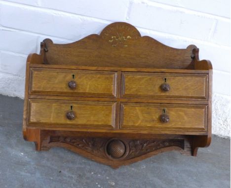 Golf Interest: an oak 'Club Fixtures' wall shelf with four drawers, golf ball and thistle carving, 41 x 37 x 18cm