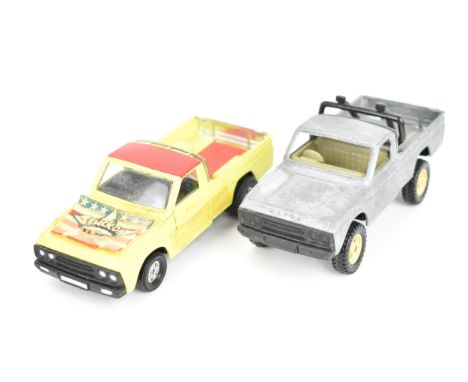 Corgi Toys - a pair of pre-production Mazda B1600 pick-up trucks, unboxed, one decorated in yellow and red with 'Truck-on USA