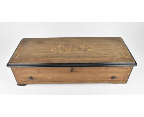 A late 19th century inlaid cylinder music box, playing eight airs, the brass cylinder with graduated comb, the rosewood lid a