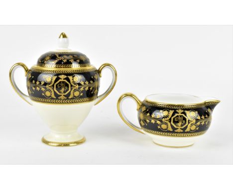 A Wedgwood porcelain lidded urn, in the 'Astbury' pattern, with twin-handles, the black banded top section and lid with appli