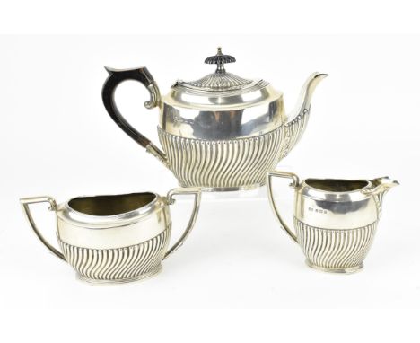 An Edwardian silver three piece tea set by Lister &amp; Hayden, Birmingham 1905, comrprising a teapot, twin-handled sugar pot