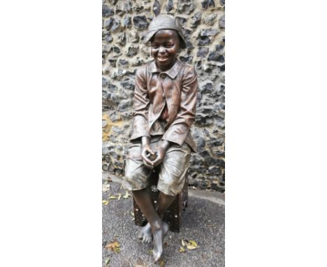 Friedrick Goldscheider (1845-1897): a lifesize Austrian painted terracotta figure of a young boy seated on a Middle Eastern o