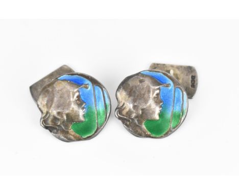 A pair of silver and enamel Art Nouveau style cuff links, of circular form with hammered silver profile portrait against a bl