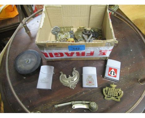 A group of brass and other metal cap badges to include Royal Gloucestershire Hussars, two Zippo cigarette lighters and a Xeni