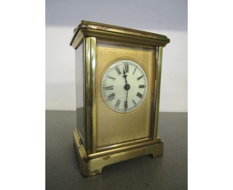 Ab early 20th century brass cased carriage clock, five windows with cream enamelled Roman dial, (with key) 