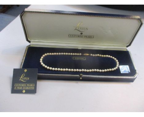 A Lotus pearl necklace with a 9ct gold clasp together with a quantity of late 20th Century Attwood and Sawyer paste broochesL