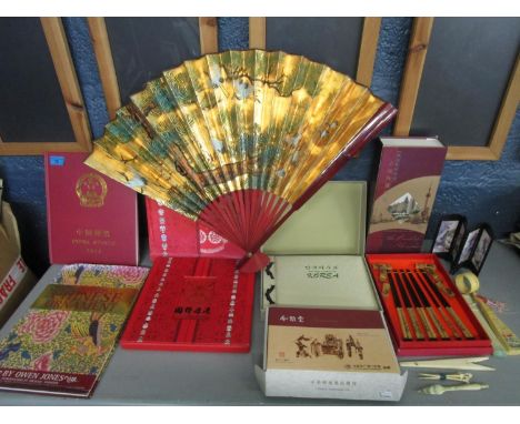 A selection of Asian items to include a boxed chopstick set, an album of Korean postage stamps, fans and other items 