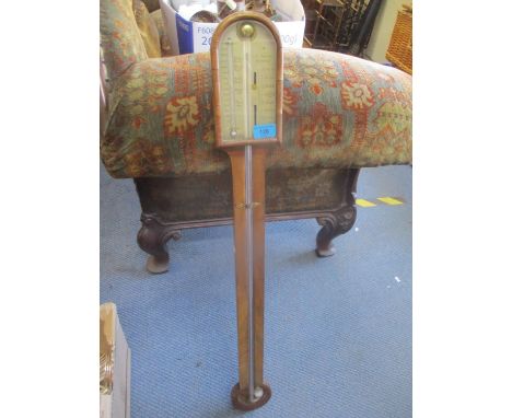 A 19th century walnut barometer having a silvered dial inscribed A.Tacchi, Bedford 36 3/4"H 