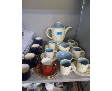 A Susie Cooper six setting in complete coffee service having a cream ground and blue star flower pattern, together with other