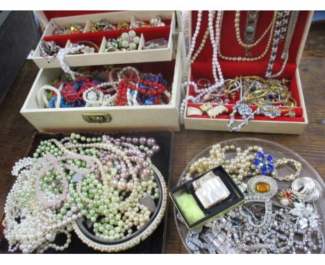 A quantity of costume jewellery to include earrings and beads together with a 1970's jewellery box and a Ronson mother of pea