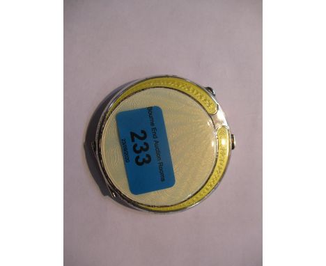 An enamelled silver compact with engine turned decoration 