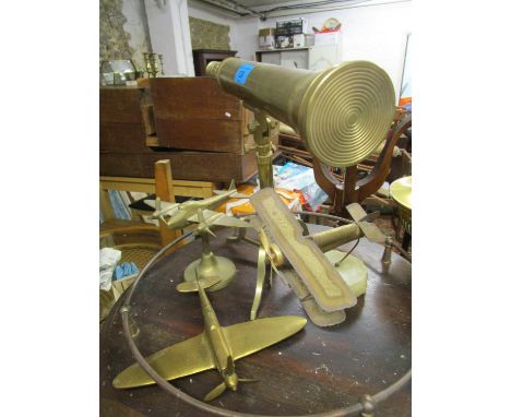 A reproduction brass telescope on tripod base, a metal model of a bi-plane mounted on an onyx stone base, signed and two bras