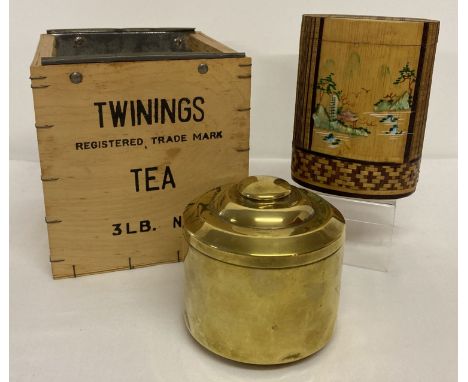 A metal lined Twinings wooden tea chest together with 2 tea caddy's.  An Art Deco circular shaped brass caddy and an Oriental