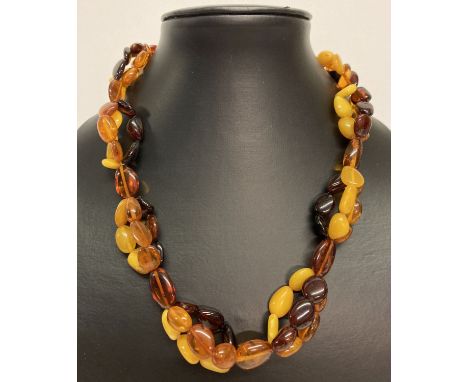 A modern design, tri colour amber bead necklace with silver lobster style clasp and extension chain.   Total length approx. 1