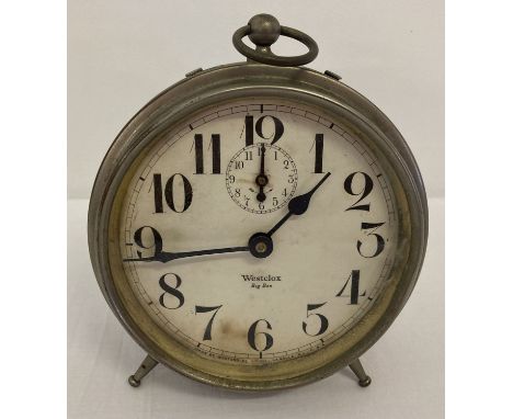 A 1920's metal cased Westclox Big Ben alarm clock with white face.  Raised on 2 period style screw-in feet with central suppo