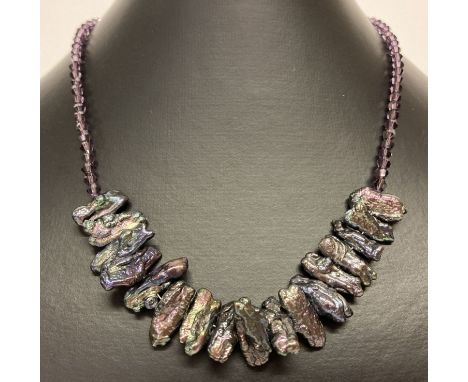 A freshwater peacock keshi pearl and purple glass beaded necklace.  With silver S shaped clasp.  Approx. 16".