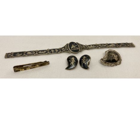 A collection of vintage Siam silver Niello jewellery.  Comprising: a tear drop shaped brooch, a pair of clip on earrings, a l