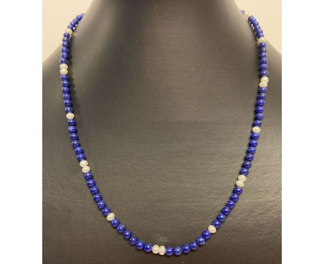 A small lapis lazuli and pearl bead necklace with gold spring style clasp.  Clasp marked 9K.  Approx. 18 inches long.