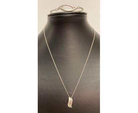 A modern wave design pendant in plain and brushed silver on an 18" fine curb chain.  Together with a modern design silver ban