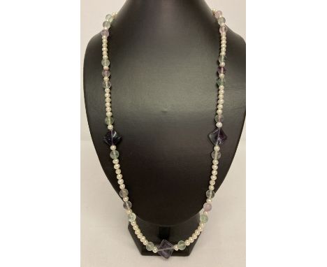 A 28" freshwater pearl and fluorite beaded necklace with white metal flower shaped push clasp.  
