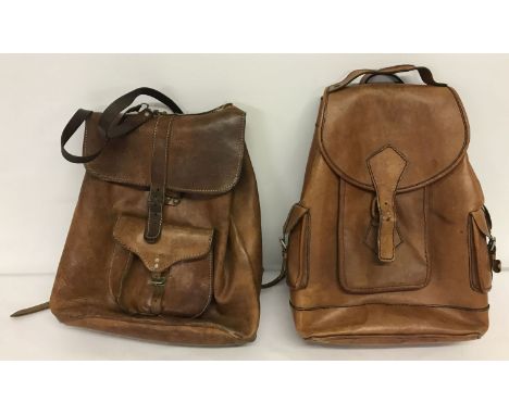 2 vintage brown leather rucksack bags. Both with front buckle and drawstring fastening.  Both have small exterior pocket to f