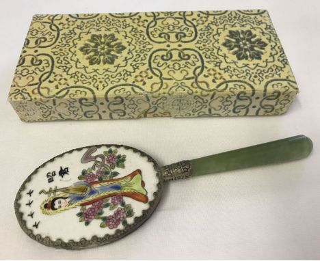 A vintage Chinese jade handled small vanity mirror with enamelled back depicting an oriental lady.  In original box.  Approx.