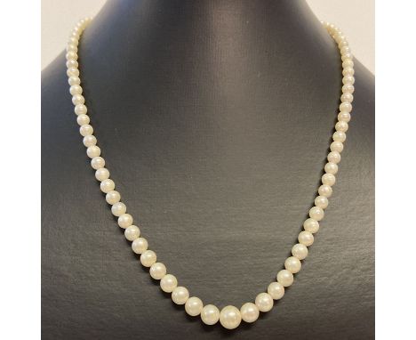 A vintage graduating cream pearl necklace with silver clasp.  Clasp set with marcasite stones (some missing) and marked 'ster